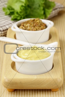 French mustard sauce in white gravy boat