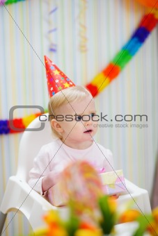 Celebrating birthday baby looking in corner