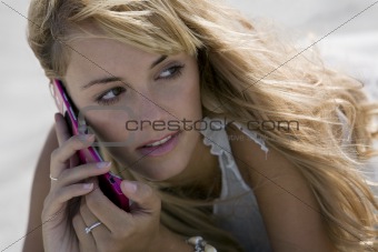 Young blonde woman talking with mobile-phone