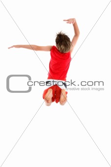 Boy jumping arms in grande pose.