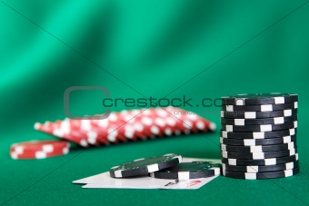 Stack of chips and two aces