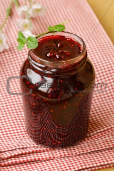raspberry jam on a wooden table, rustic style