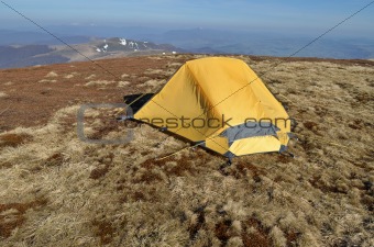 Dawn in the mountains and yellow tent 
