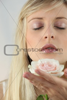 Blond woman holding flower