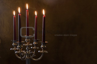 Five red candles lighted on painted room