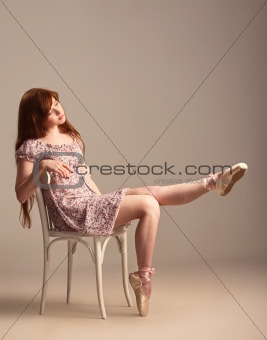 Redhead girl trying on pointe shoes