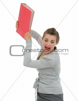 Angry business woman throwing folder in rage