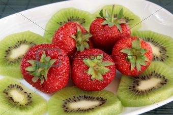 Kiwi and strawberries on a white dish