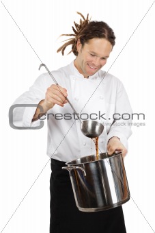 Chef preparing soup in large pot