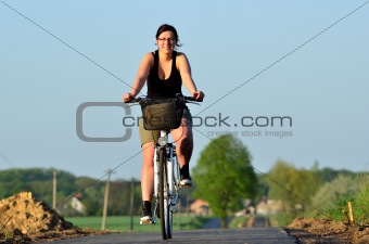 Young woman riding a new bicycle path