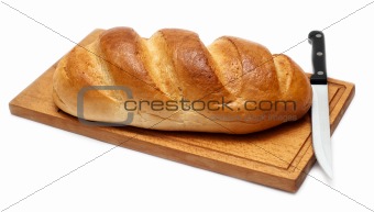 bread with knife on breadboard