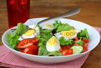 salad with eggs and  fresh vegetables,  on a plate