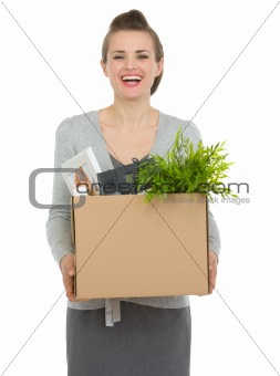 Happy woman employee holding box with personal items