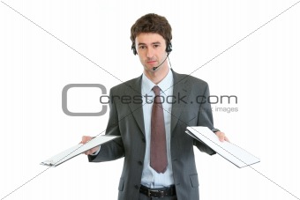 Business operator with headset confused in pile documents