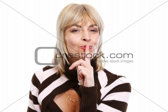 Senior woman showing shh gesture