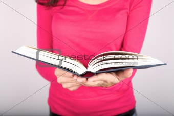 pink lady holding book