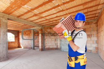 Worker carry brick on construction site