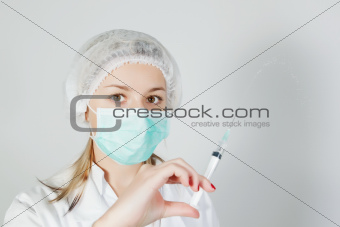 A nurse with a prick and a mask.
