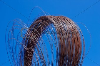 Rusty wire against blue sky