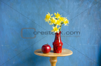 vase with narcissus and red apple