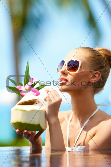 Woman drinking tropical cocktail