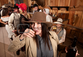 Cowgirl Sips Whiskey in Tavern