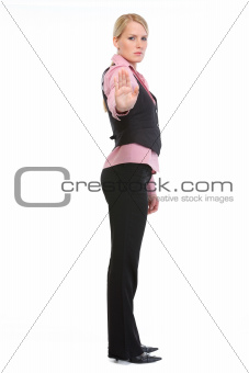 Full length portrait of employee woman showing stop gesture