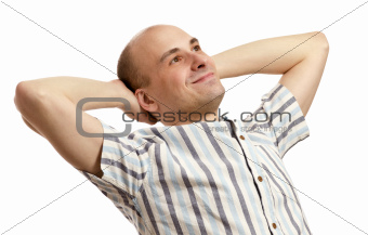 Portrait of handsome man relaxing with hands behind head