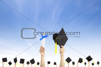 hand holding graduation hats and diploma certificate with cloud background