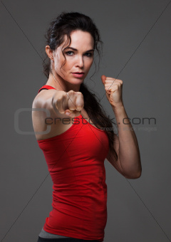 Attractive woman throwing a pucnh