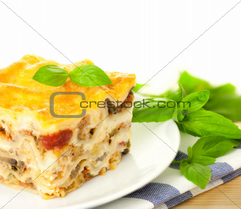 Delicious Italian Lasagna / with fresh basil / white background 
