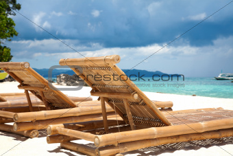 Wooden deck chairs on beach