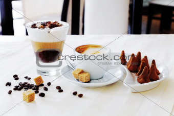 coffee and sweat candies on white table