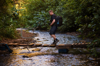 Hiker Crosses Stream