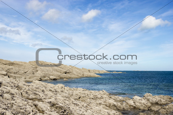 rocky coast of northern France against the blue sky