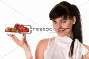 Playful woman with strawberries on plate