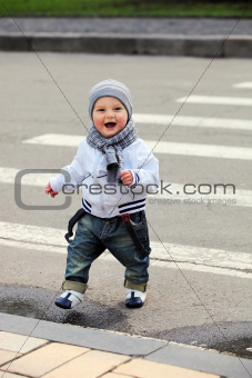 Little boy crossing a street