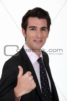 Smiling businessman giving the thumb's up