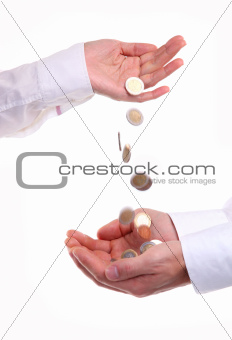 Female hand pour down coins into male hands