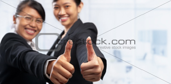 Two Asian businesswoman with thumbs up