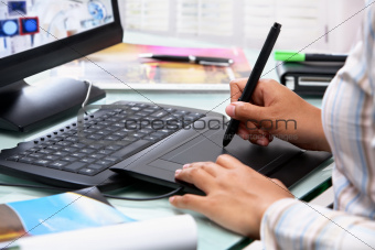 Female graphic designer using tablet pen