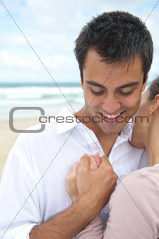 Latin man and girlfriend on the beach
