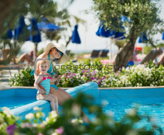 Mother with baby sitting in open air pool