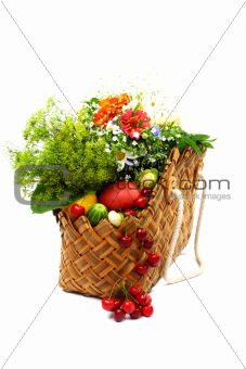 Summer fruits, vegetables and flowers in a basket