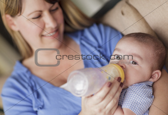 Happy Mother Bottle Feading Her Very Content Son.