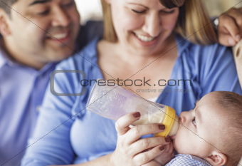 Happy Attractive Mixed Race Couple Bottle Feeding Thier Son.