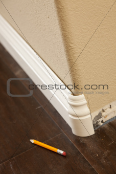 New Baseboard and Bull Nose Corners with Laminate Flooring Abstract.