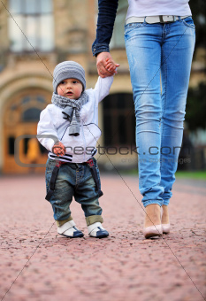 Toddler holding mother's hand