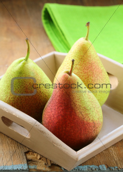 three ripe juicy pear on a wooden table