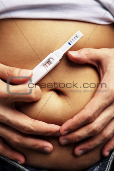 Male hand embrace pregnanct stomach